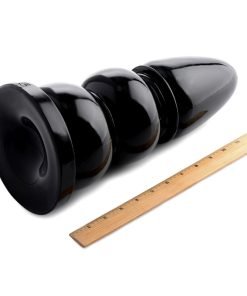 Black silicone toy with graduated size and ruler for scale