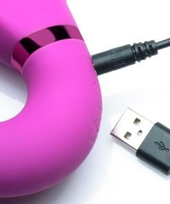 Close-up of a pink silicone device with USB charging cable