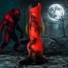 A striking red figure in a dark forest with a werewolf in the background