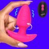 A hand holding a pink silicone sex toy against a vibrant blue background.
