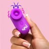 A hand holding a vibrant purple device with a rounded top, designed for personal enjoyment.