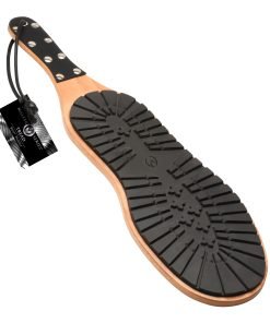 Rubber sole of a shoe with a wooden base and a tag attached
