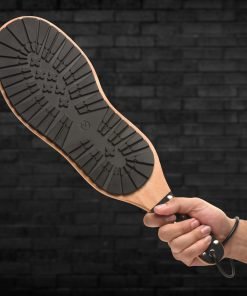 Hand holding a unique paddle with a rubberized sole