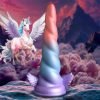 Colorful unicorn-themed fantasy sculpture in a mystical landscape
