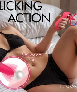 Woman holding a pink intimate device on a bed