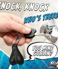 A hand inserting a key into a door lock with a humorous keychain