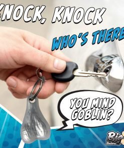 A hand holding a key with a novelty keychain while unlocking a door