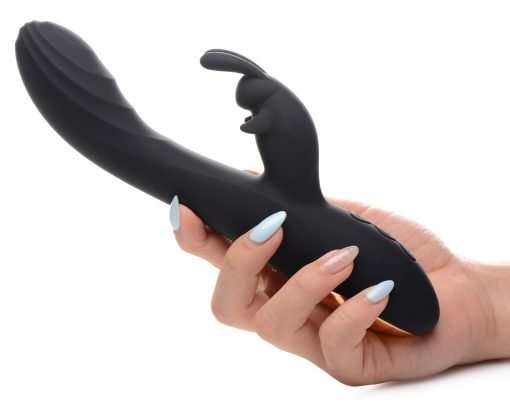 A person holding a sleek black adult toy with a unique design
