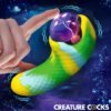 A colorful, textured fantasy creature toy being touched by a finger