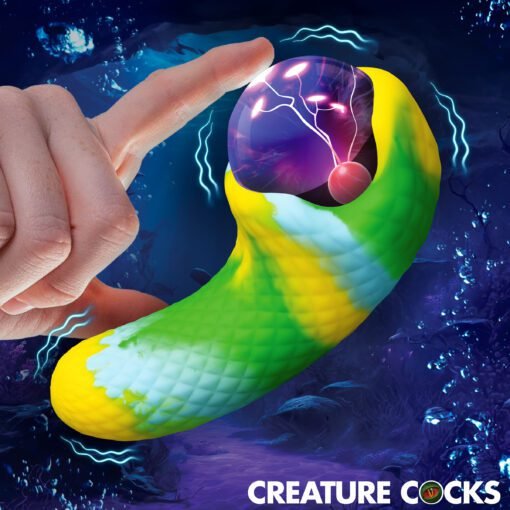 A colorful, textured fantasy creature toy being touched by a finger