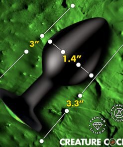 A black silicone product with measurements displayed on a textured green background.