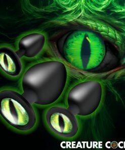 Black plugs with green eye designs on a mystical background