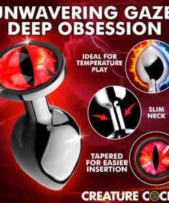 A close-up of a unique anal plug designed for temperature play, featuring a striking red eye design.