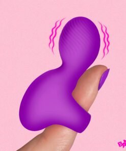 Vibrant purple silicone toy held between fingers against a pink background