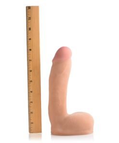 Realistic silicone dildo next to a ruler for size reference