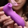 A close-up of a purple personal massager being held by a person.
