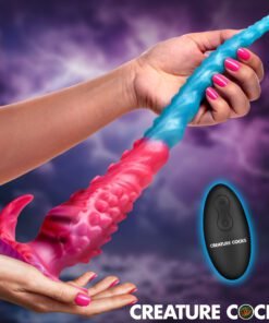 Colorful creature-inspired toy held in hand with a remote control nearby